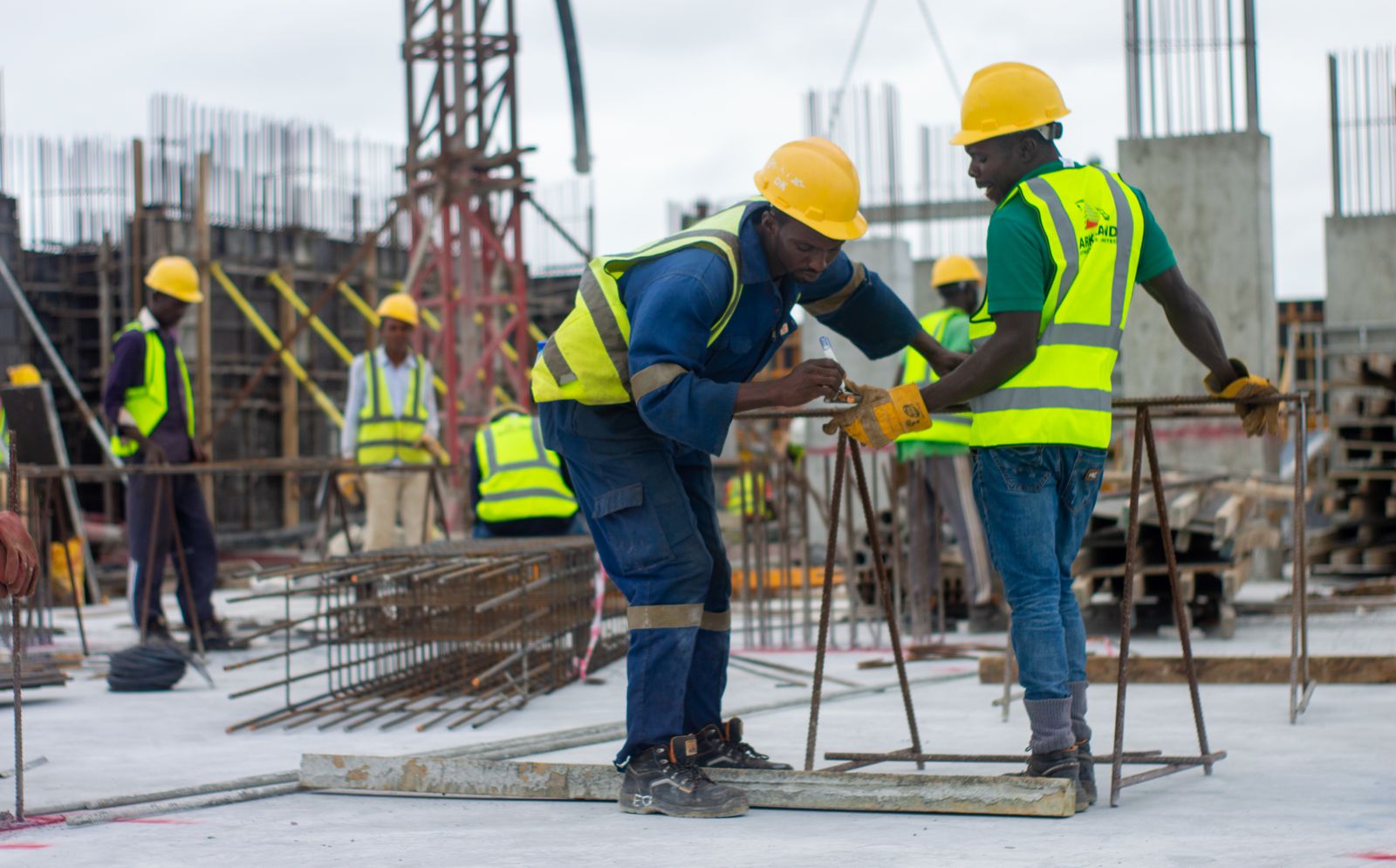 Construction workers preparing steel reinforcement on site